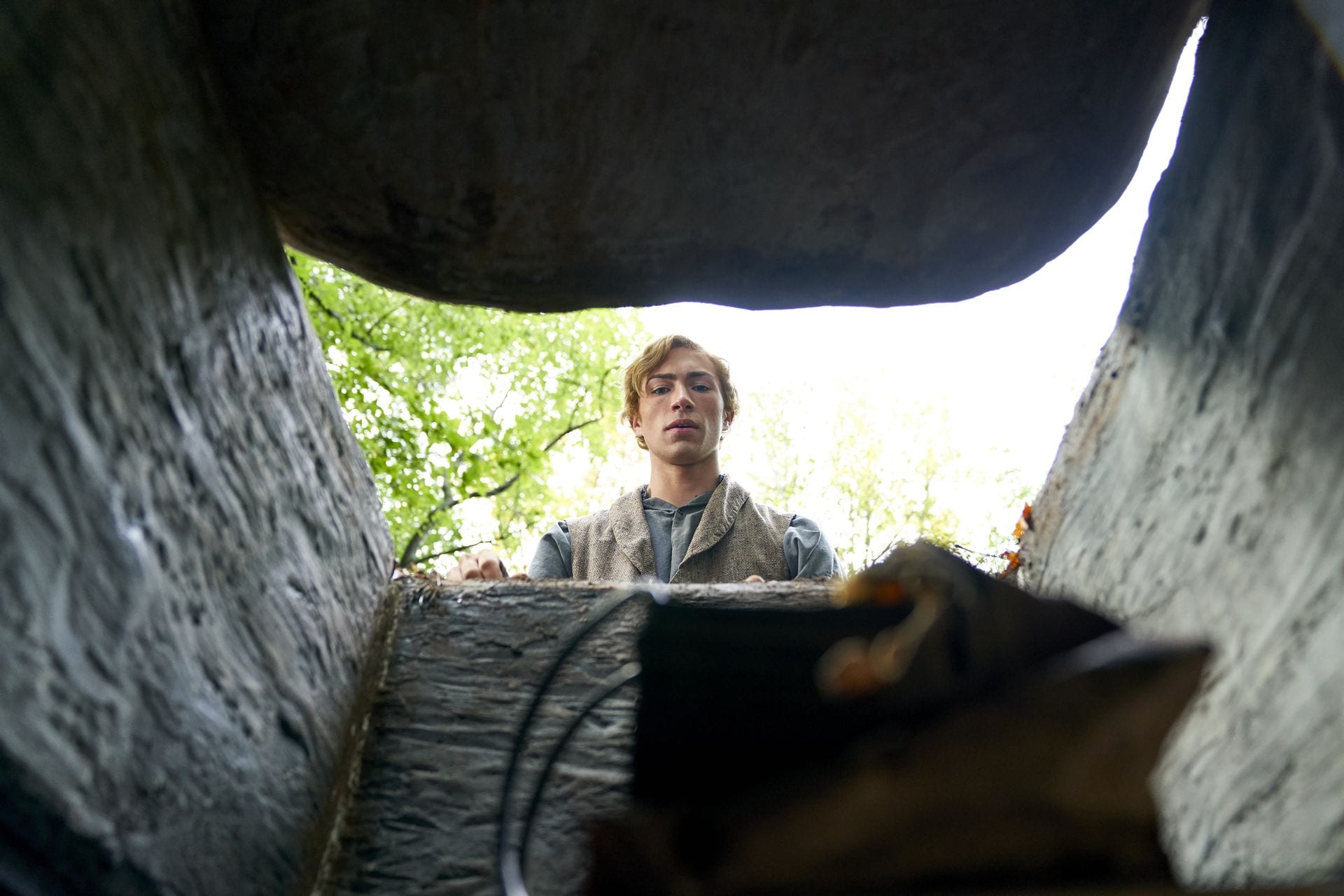 Joseph Smith retreiving the gold plates from the hole in the hill